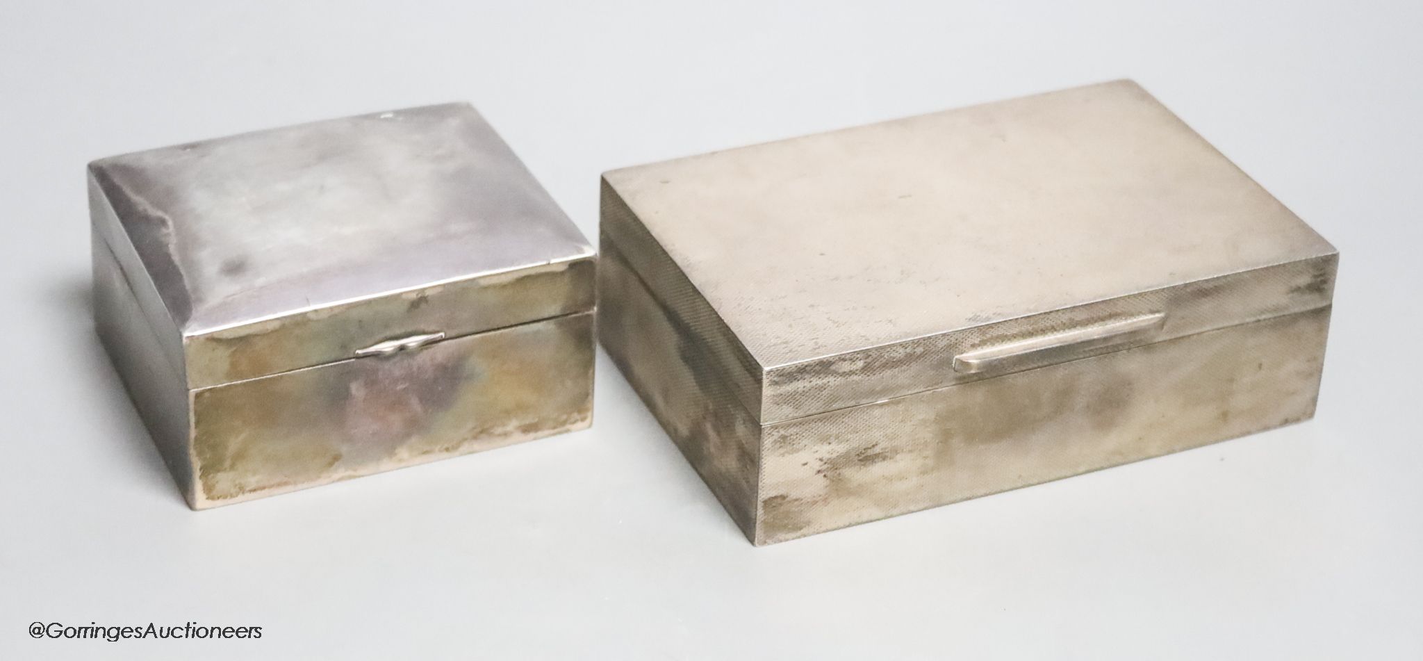 A 1950's engine turned silver cigarette box by Asprey & Co, 14cm and a sterling cigarette box by Tientsin Yeching, 91mm